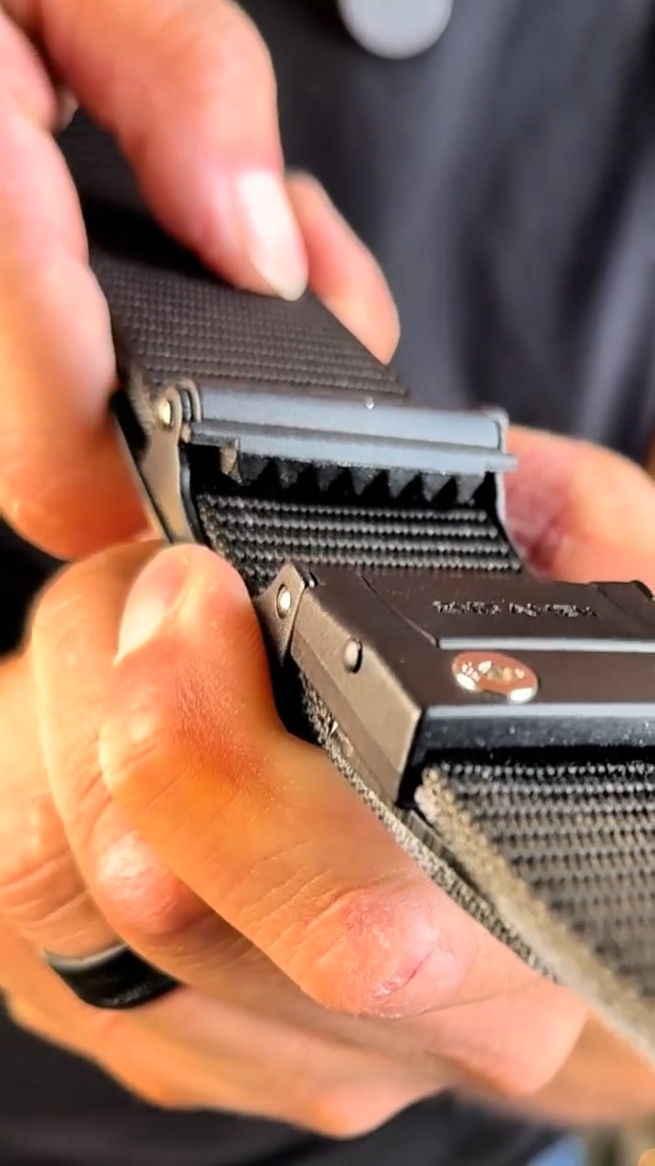 The OPS 1.0 buckle opened to show the row of metal teeth inside